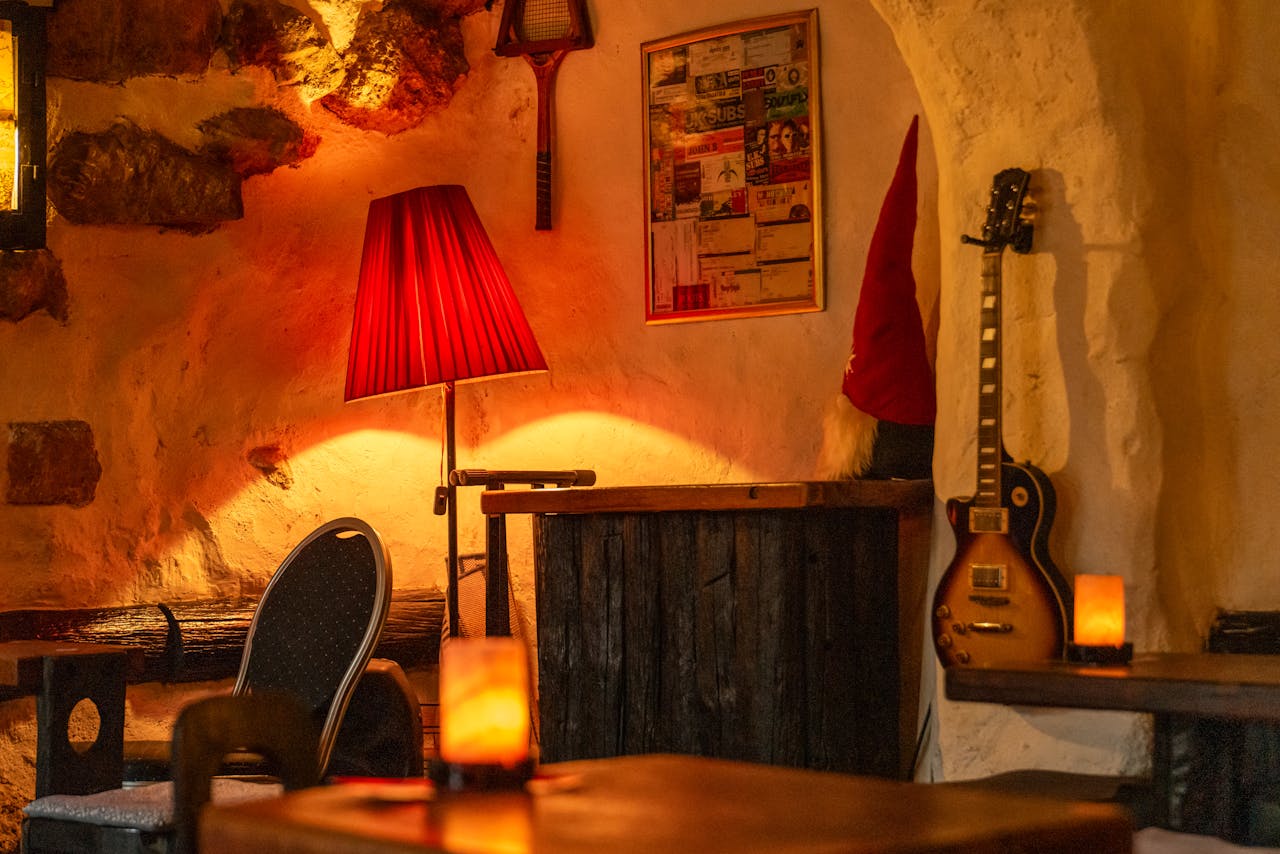 services-02 Warm, cozy bar interior featuring vintage decor, warm lighting, and a guitar in Zagreb.